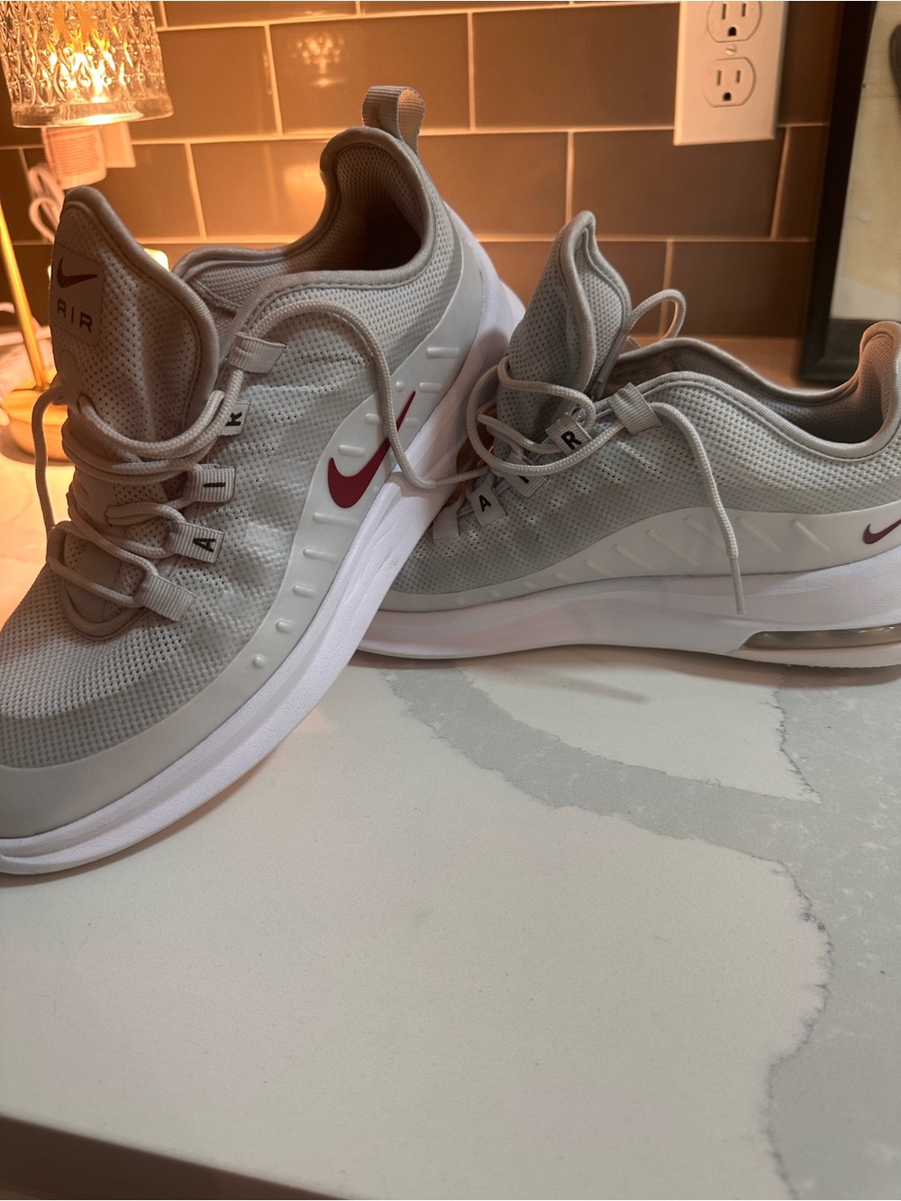 Nike Air Max Axis in the Pure Platinum / Red Crash / White colorway. Womenâs 10